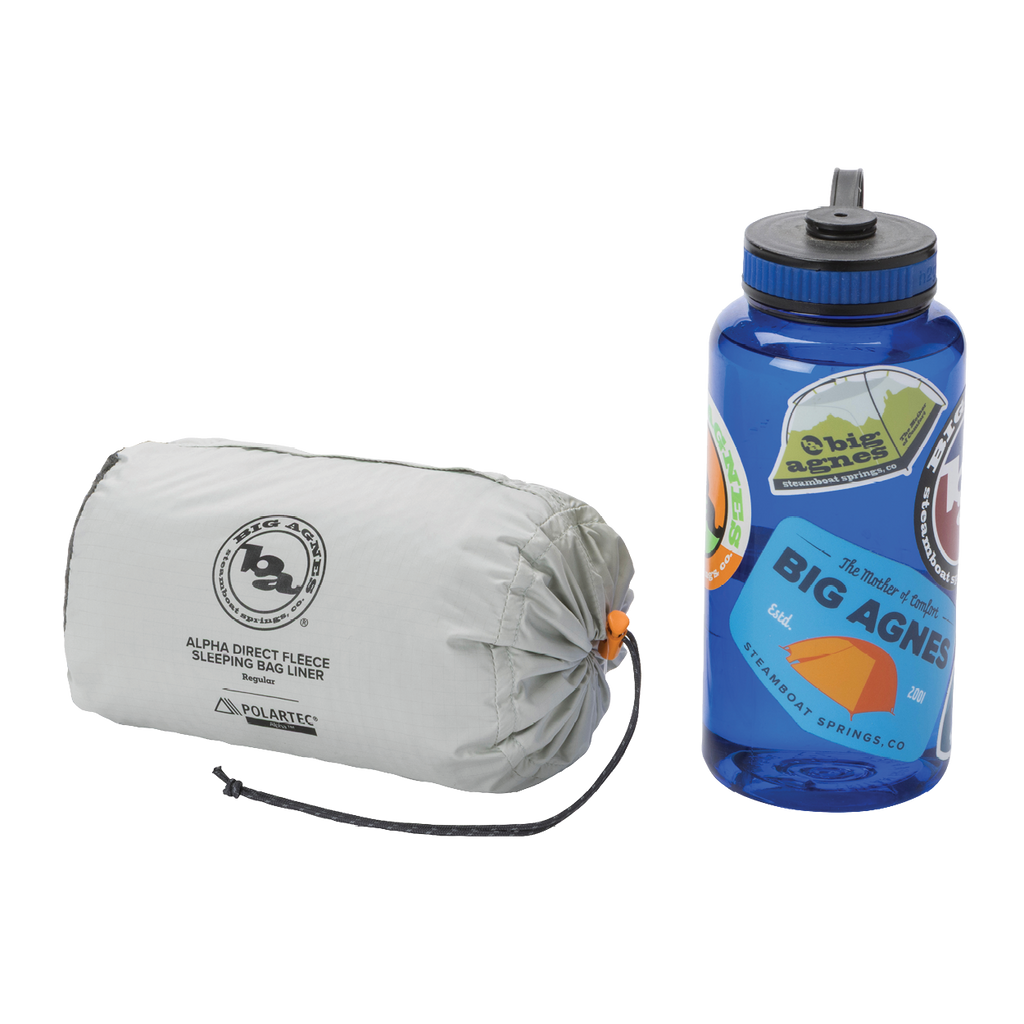 Sleeping bag liner and water bottle with Big Agnes Returns branding on a white background