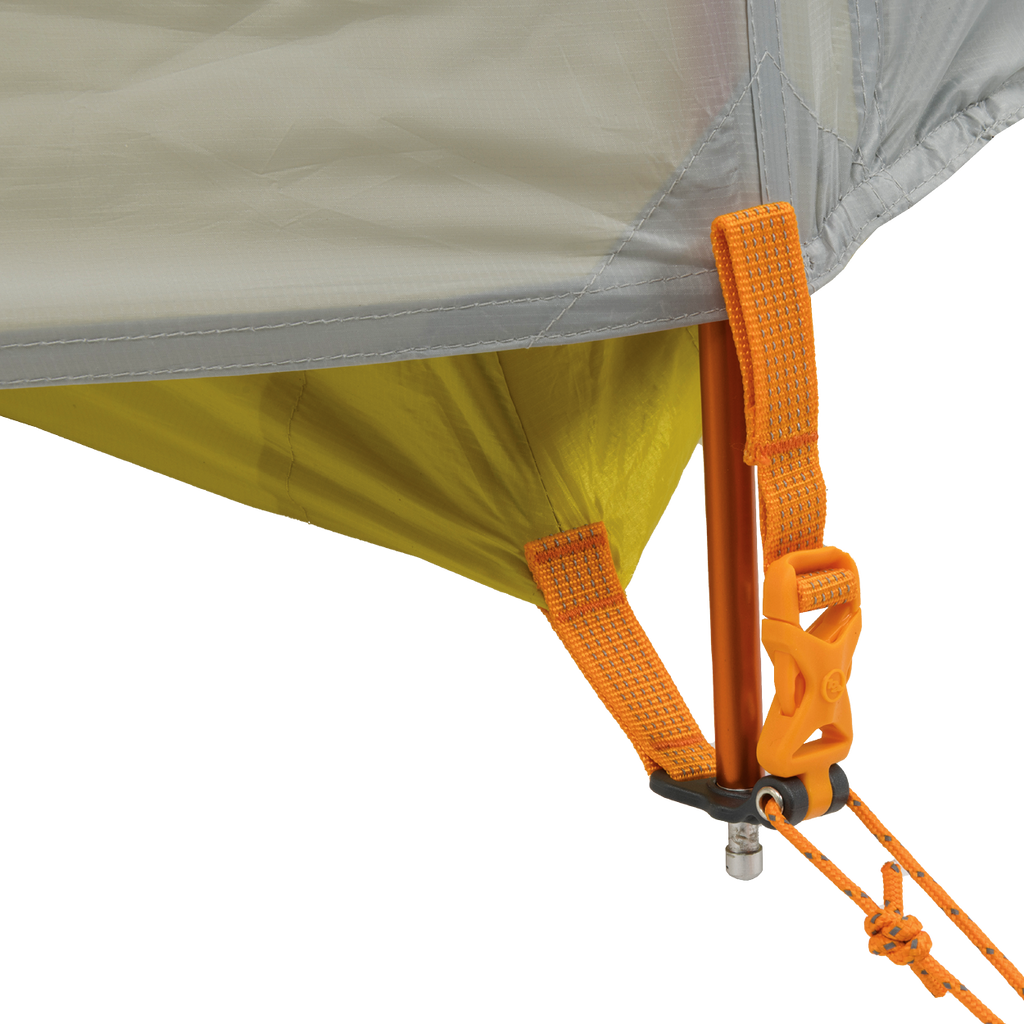 Close-up of the Big Agnes Salt Creek 2 tent corner reveals orange straps, yellow fabric, and an orange pole secured by a metal pin, clip, and guyline—perfect for campers seeking durable gear with panoramic views.